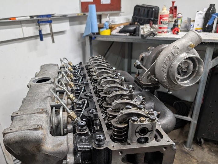 Engine block with turbocharger in a workshop setting