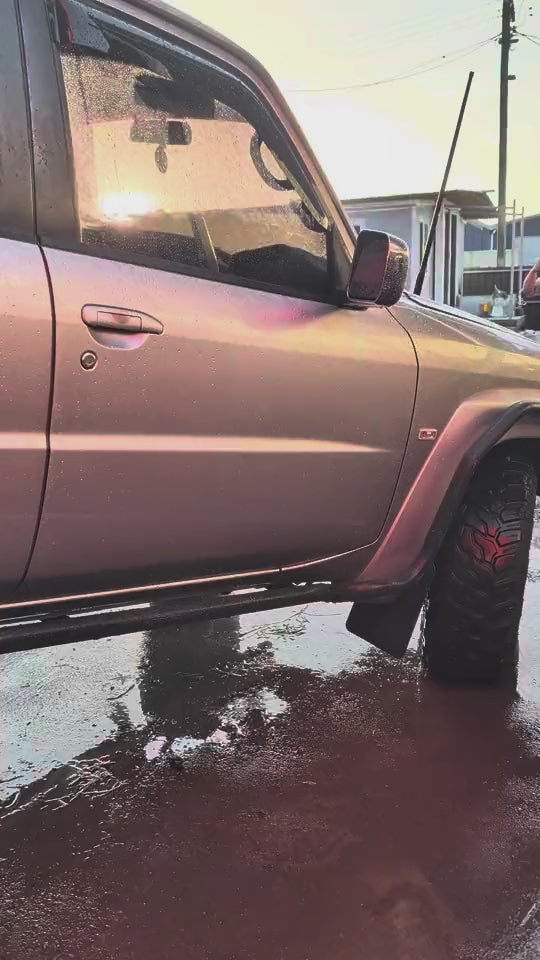 Nissan Patrol flexing its suspension on a ramp in Cairns